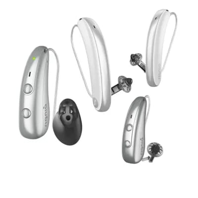 collection of silver behind the ear and in the ear hearing aids with silicone ear tips arranged on a white background signia ix lineup signia 3 vs 5 vs 7 where your money goes as you move up the audiology place