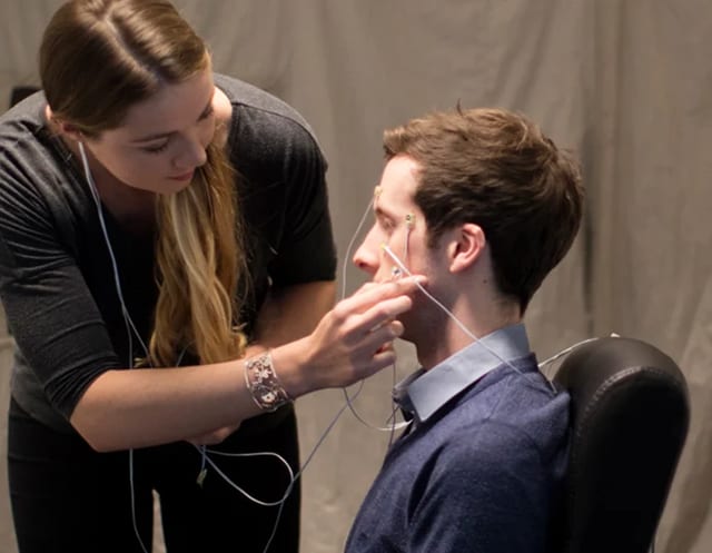 researcher attaches electrode wires to a mans face for a neurological test or measurement session lenire trials lenire cost australia the audiology place