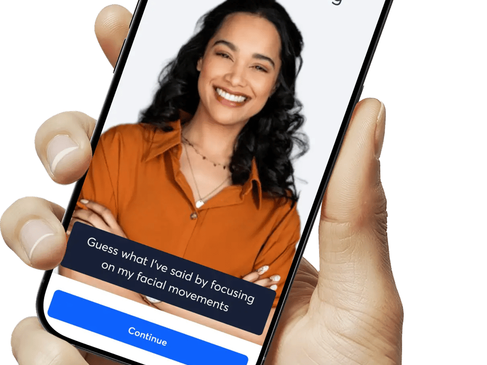 Smartphone screen showing SunnySound Speech Reading app with a smiling woman; prompt reads about guessing words from facial movements and a Continue button.