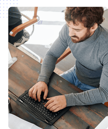 Man engaging in employee task tracking best practices on laptop | Hubstaff
