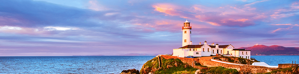 A towering lighthouse standing sentinel by the Irish sea, with rolling hills and majestic mountains framing the background, symbolizing guidance and unity in the spirit of Meitheal.