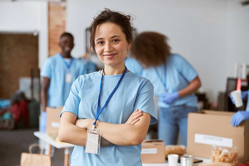 Volunteer at timebank ireland community service smiling woman in medical scrubs.