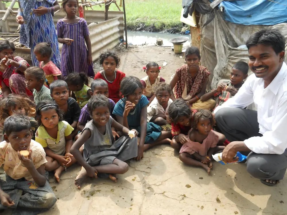 Pastor Rambabu with children and food