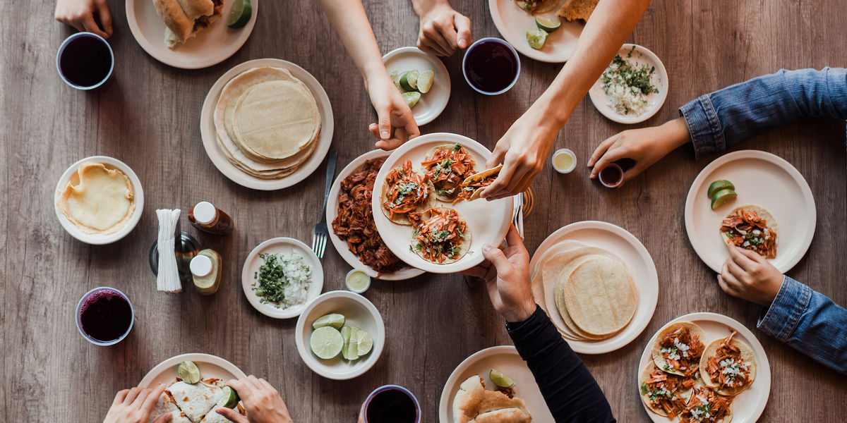 Big table of tacos and taco toppings, fillings etc