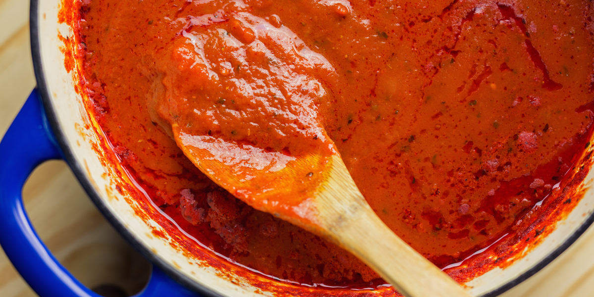 247 Easy Marijuana Edibles Recipes to Make at Home 135 a pot of spaghetti sauce with a spoon in it