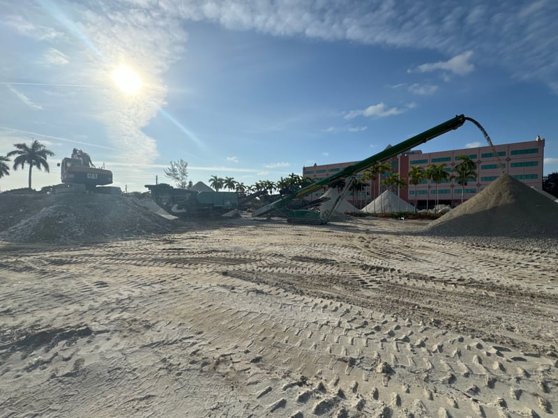 Mobile jaw crusher processing concrete demolition debris on a South Florida job site