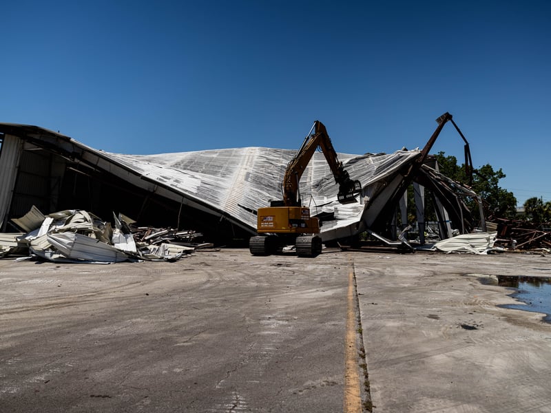 Excavator bringing down the roof section of an aircraft hangar at Boca Raton Executive Airport, 2026