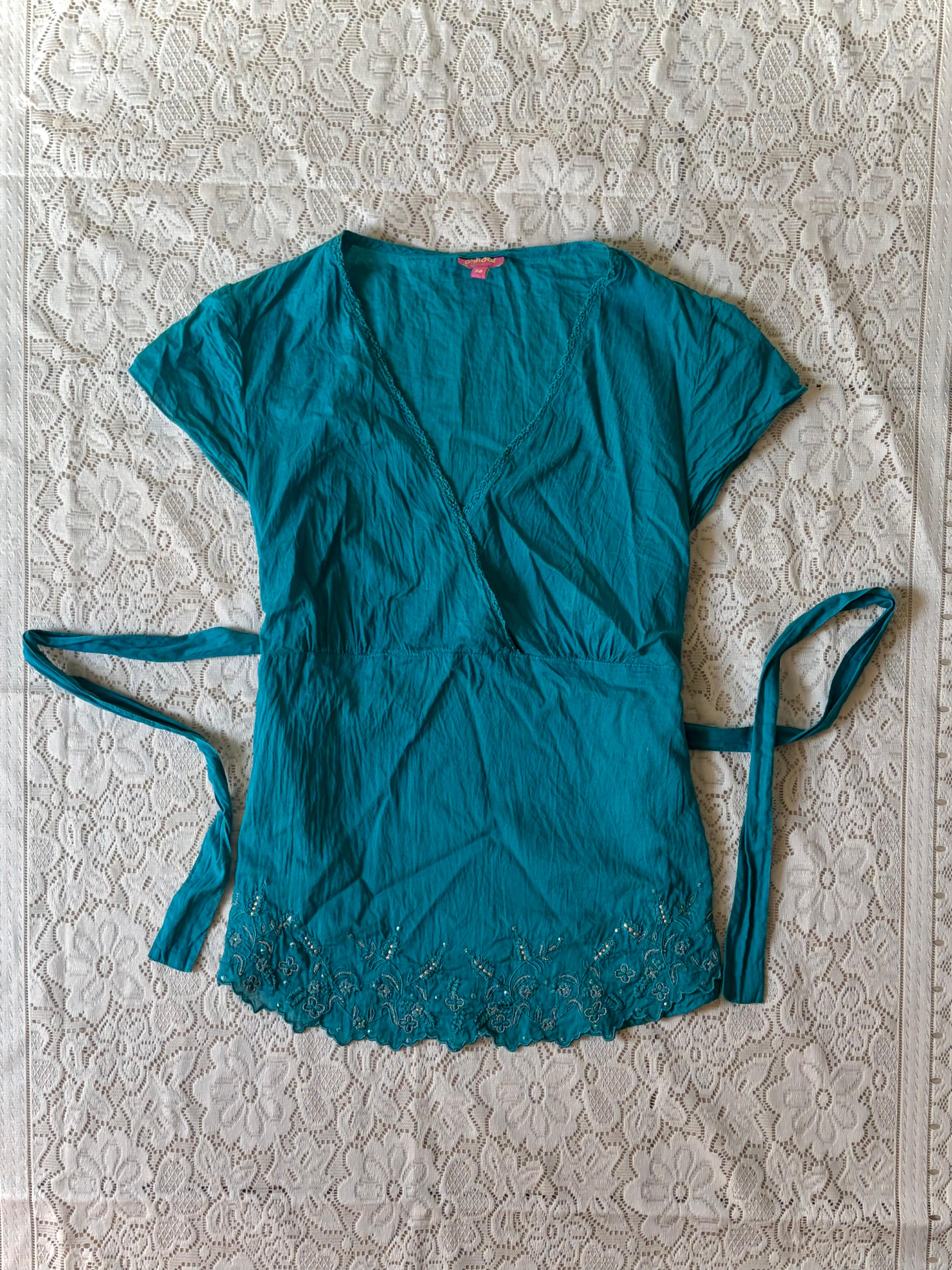Product: Teal cotton wrap top with embroidered hem