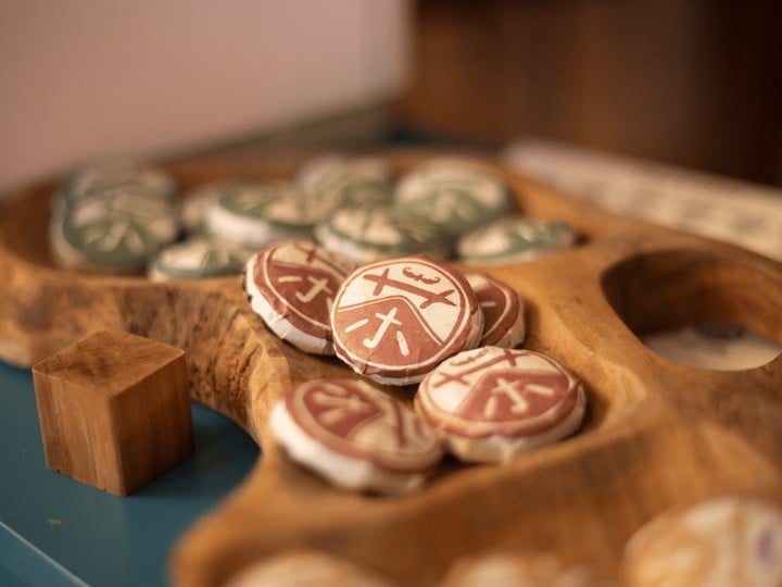 Mahjong tiles in wooden bowl on studio table