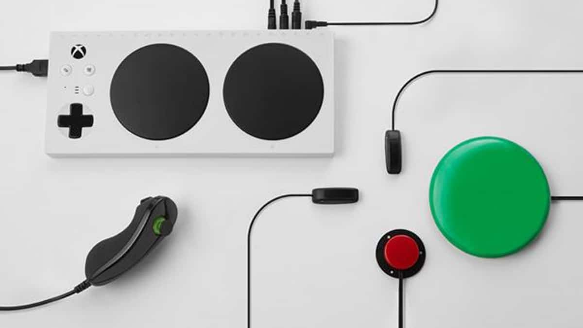 Fotografía del control de una consola de videojuegos adaptado para personas con movilidad reducida. En la imagen se ve un tablero blanco con aditamentos en color negro, un botón rojo y otro verde, que es como seis veces más grande que el rojo.