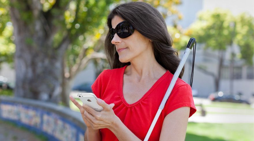 Mujer ciega utilizando un teléfono móvil.