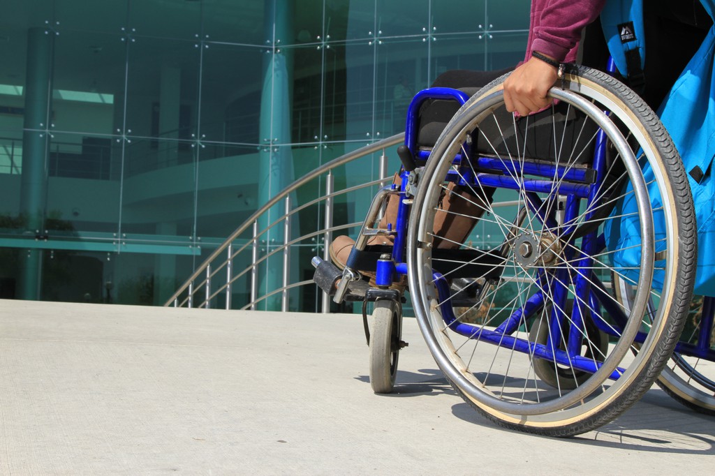 Usuario de silla de ruedas frente a una rampa de la UDG.
