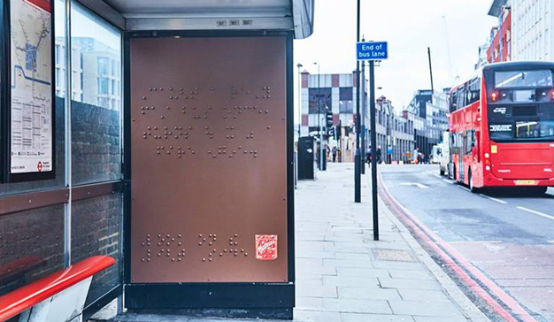 Anuncio en la parada de autobús con relieve en braille.