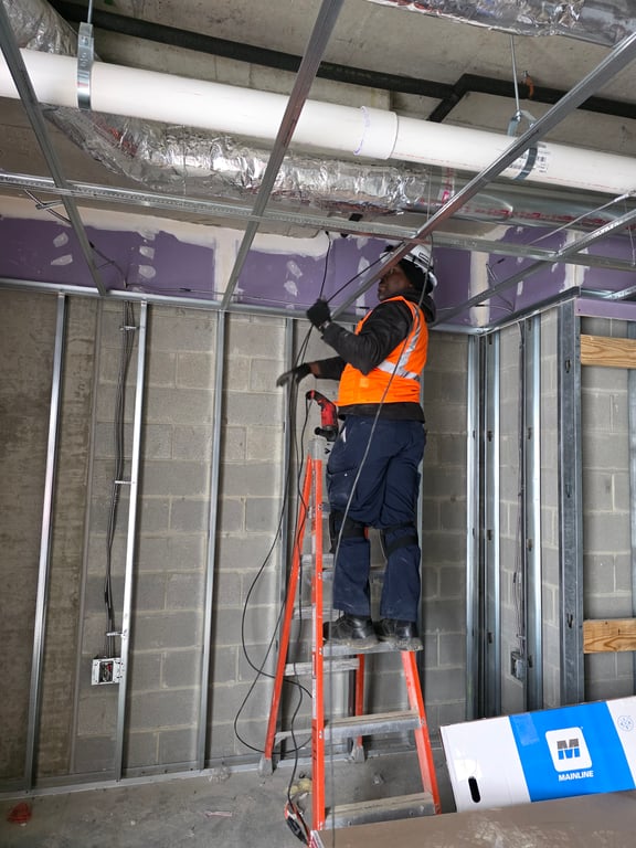 Professional telecom installation technician on ladder