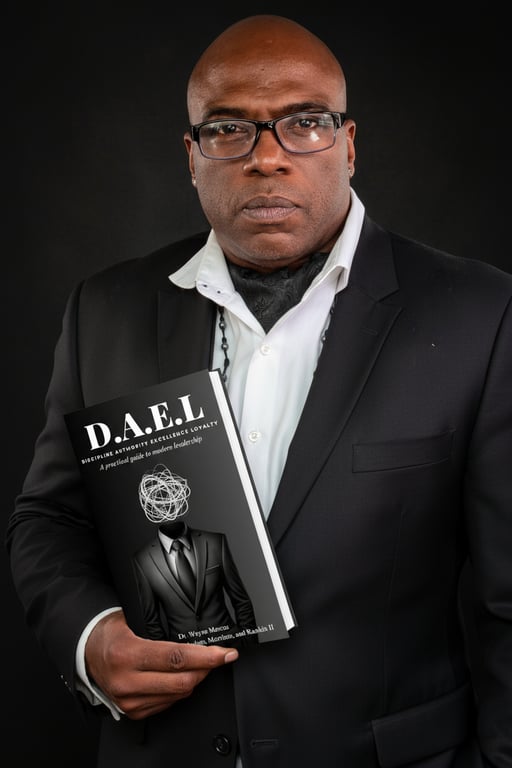 Dr. Wayne Marcus holding D.A.E.L book