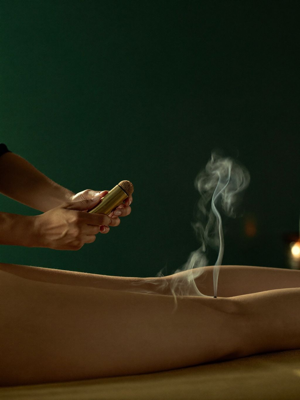 Therapeutic moxibustion applied during a leg massage