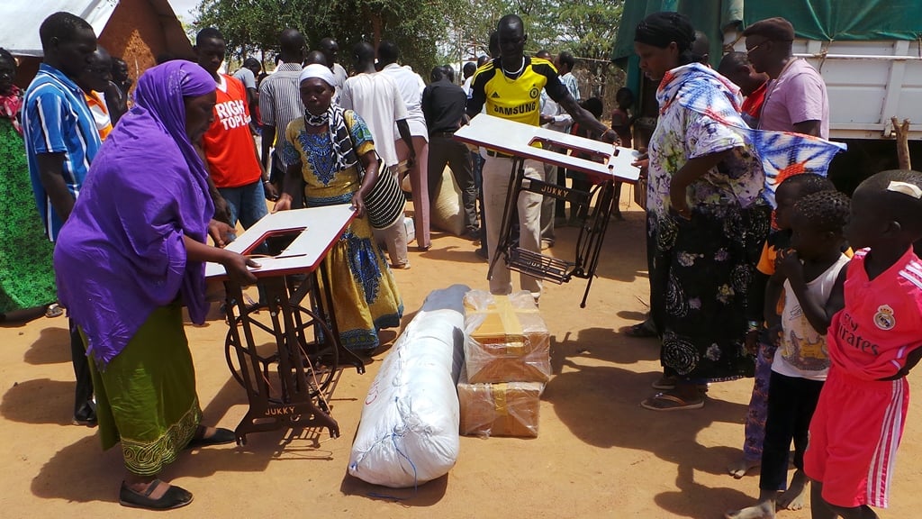 Children at refugee camp community gathering with youth participants