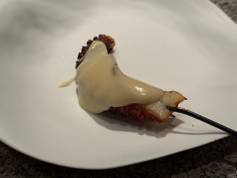 串に刺した明石タコの炭火焼に、キタアカリのピュレをかけたもの