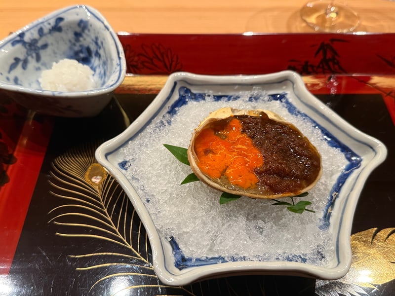 甲羅に内子と外子と身を詰めてタレに漬けた香箱蟹を、氷の上にのせた一皿