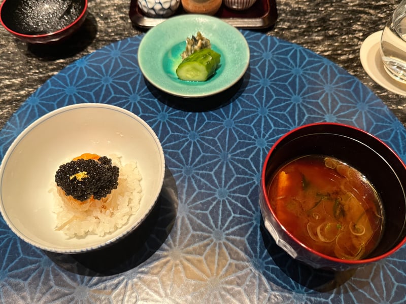 白飯に揚げた卵黄をのせ、キャビアと金箔をかけた〆の小丼。香の物と赤出汁を添えて