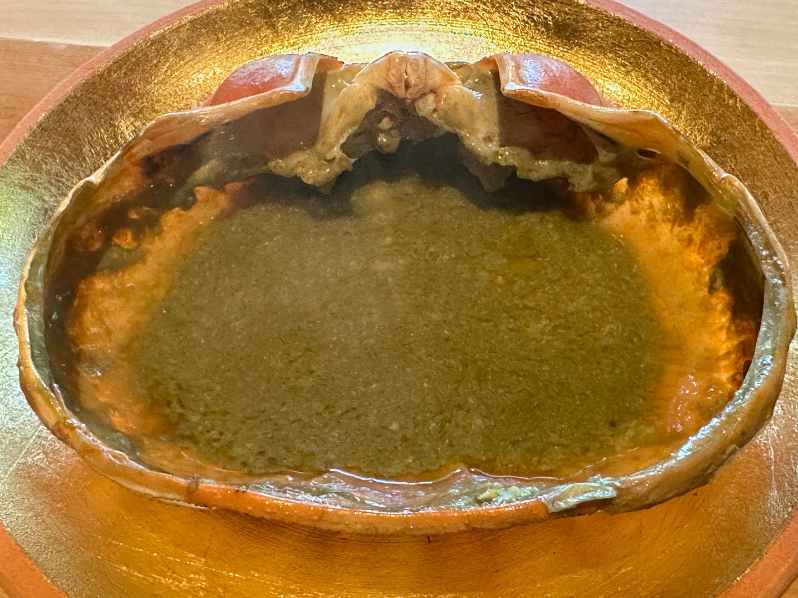 金の皿に、甲羅いっぱいの蟹味噌