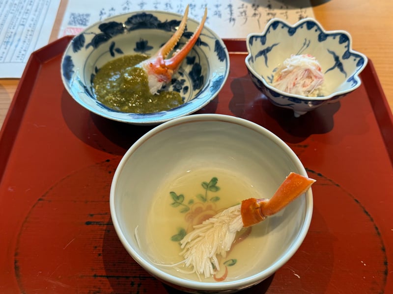 蟹しゃぶの椀、蟹味噌の鉢、ほぐした蟹身の小鉢が並んだ膳