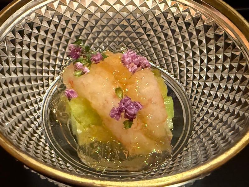 金縁の切子の鉢に、蓮芋と酢ゼリーを敷いたぼたん海老。穂紫蘇の花を散らして