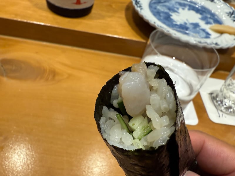 手に持った手巻き、海苔の中にとり貝のヒモときゅうり