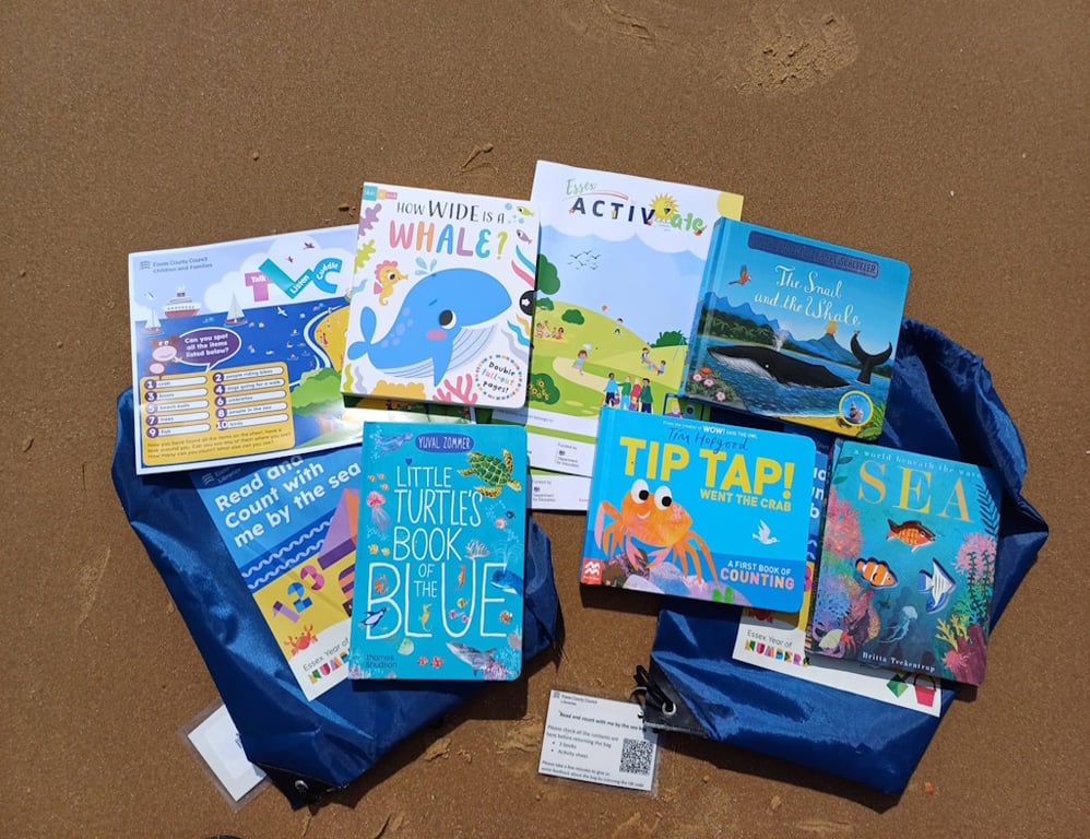 Children's books laid out on sand