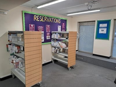 Shelves with books for customer reservations