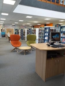 two chairs and a table in front of welcome desk