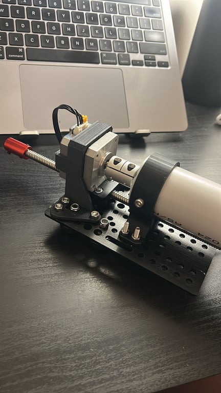 Stepper motor and lead screw assembly on a perforated base plate