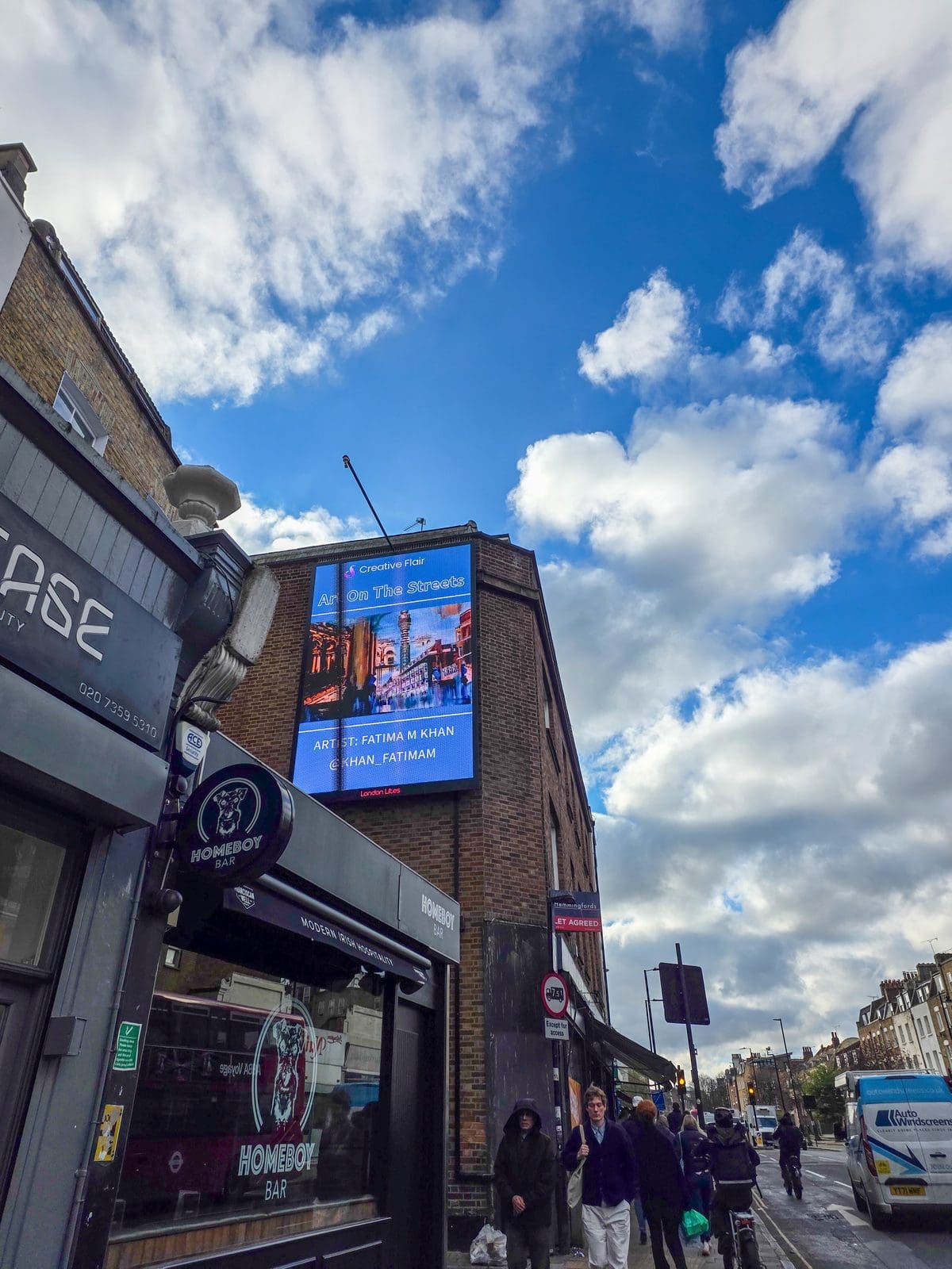 Fatima M Khan with her featured artwork on the Art On The Streets London Art Fair billboard - artist billboard exhibition during art fair week