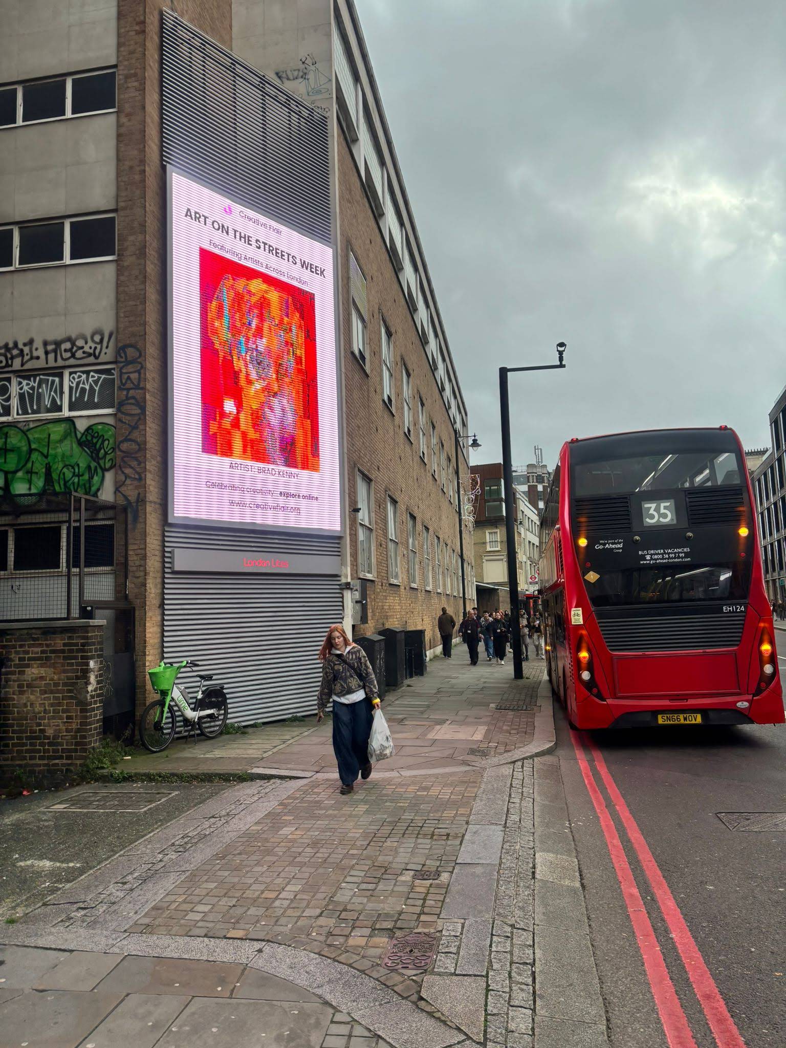 Artist work on a London billboard