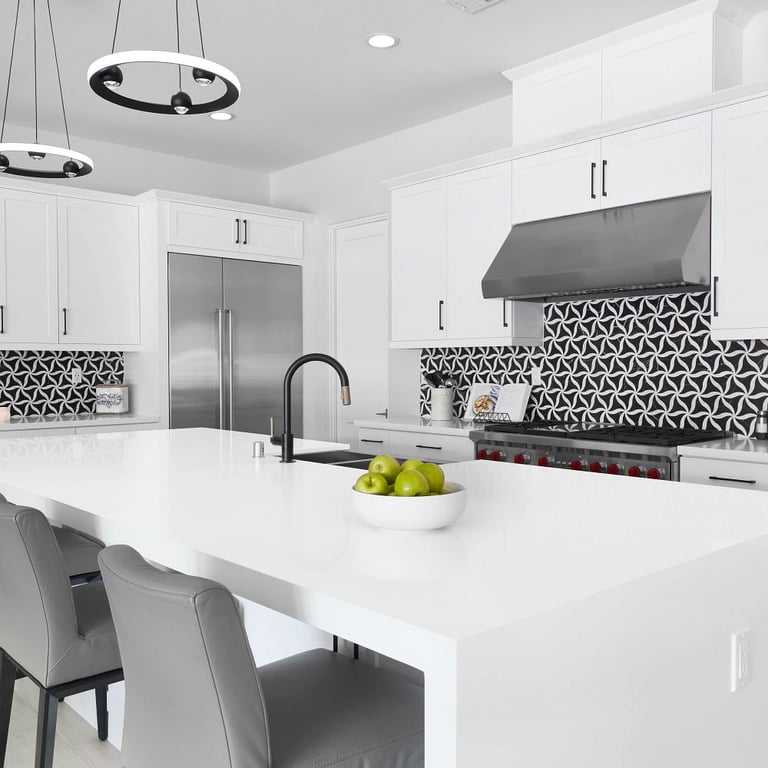 Petal Noir/Blanc Honed Marble Mesh on backsplash & Denali-N Quartz on waterfall island and counters in kitchen.