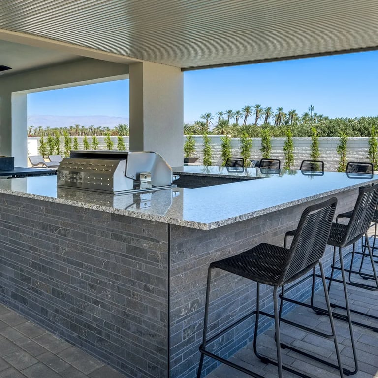 Anthea Dark Stack porcelain tile & Azul Platino Granite on countertop of outdoor kitchen.