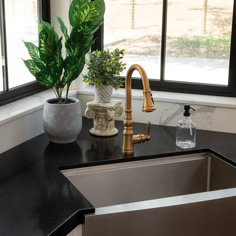 Black Mist Honed Granite countertop and Calacatta Jubilee Quartz backsplash in kitchen