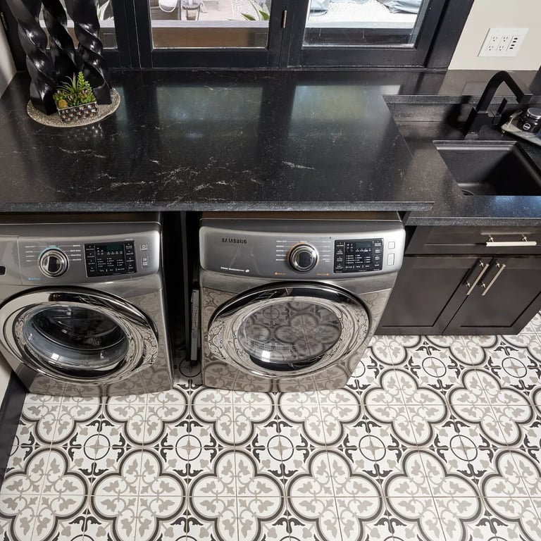 Black Mist Honed Granite on countertop and Reverie 6 - 8 x 8 porcelain tile on floor in laundry room.