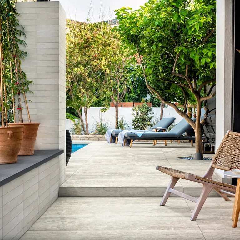 Carbon Grey Satin (wall cap, left), Glam Beige Matte 2-1/4 x 9-1/2 (wall/pillar) & Invictus Beige Vein Cut 24 x 48 R11 Finish (floor)