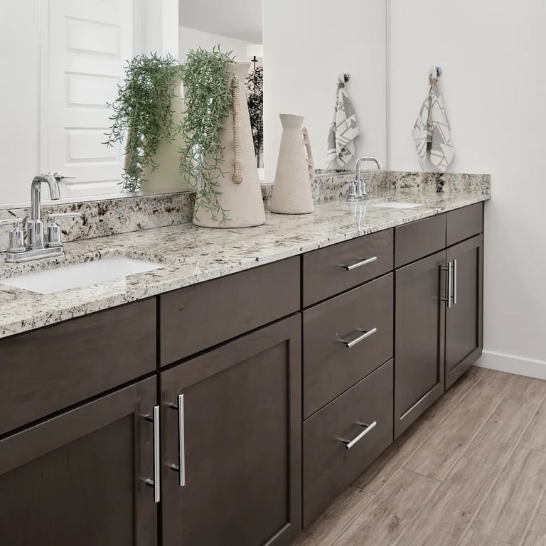White Knight granite on vanity countertops in master bathroom.