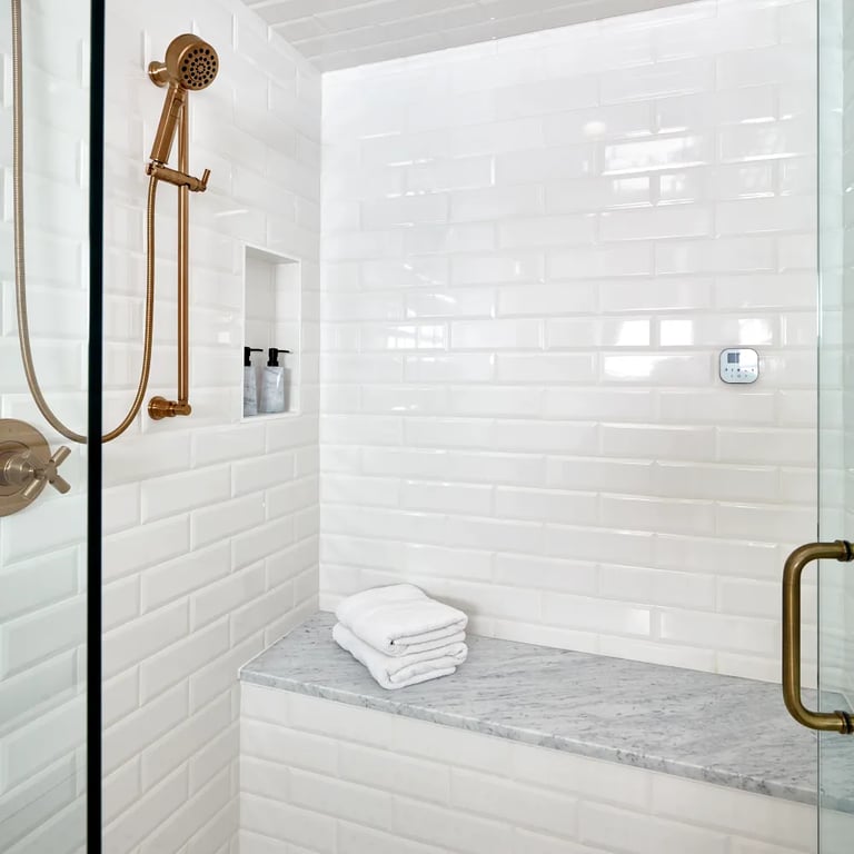 Arabescato Belgia marble (bench), Paloma Cotton Glossy Bevel 4 x 12 Ceramic tile (shower walls) & Manhattan Polished Cordoba Pattern marble (floor)