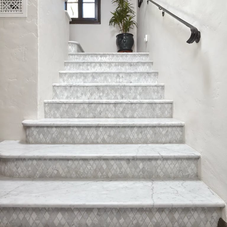Bianco Carrara Honed Marble Slab on tread & Bianco Carrara Custom Mosaic Marble on risers on staircase & Bianco Carrara Honed 12 x 24 marble on floor.