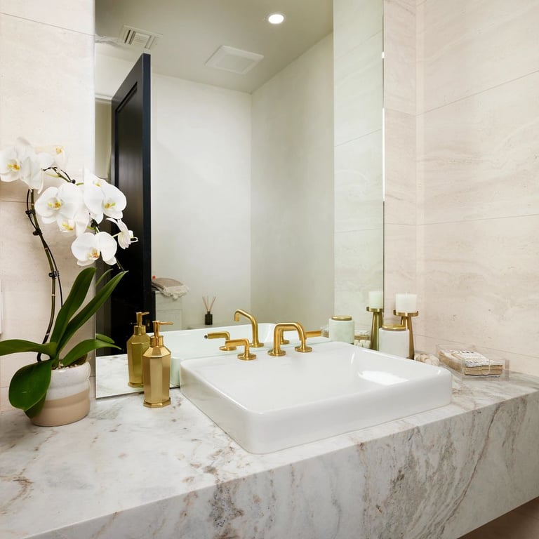 Calacatta Umber Polished marble countertop & Tivoli Beige 18 x 36 porcelain tile on walls in bathroom.