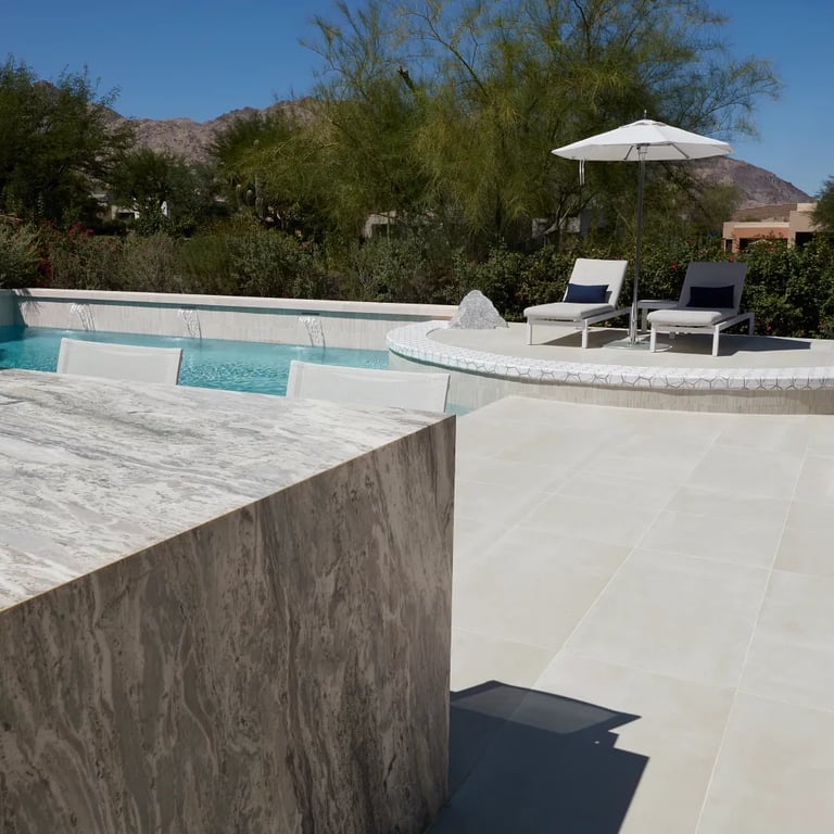 Fantasy Brown Polished (counters), Reside Beige 24 x 48 R11 Finish Porcelain (patio floor), Reside Beige Straight Stack 1 x 12 Straight Stack Porcelain (waterline) & Geo 2 Metro Uptown Glass (pool accent)