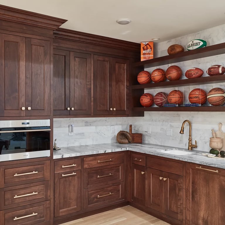Fantasy Ocean Satin marble on countertop & Calacatta Gold Honed 4 x 16 marble on backsplash on wet bar in luxury game room.