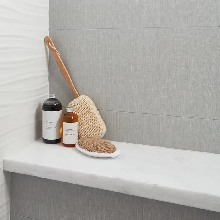 Opal White Satin on shower bench, Touch Pearl 12 x 24 on main shower wall & 3D Ribbon White Matte on left wall in bathroom shower.