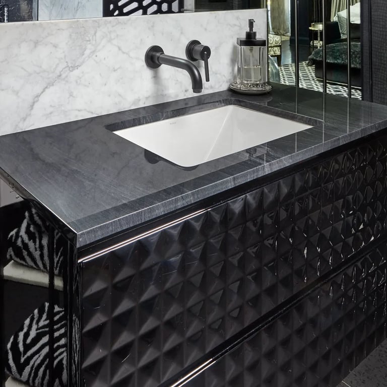 Brilliant Black Quartzite on countertop, Bianco Carrara Polished Marble 24 x 48 on backsplash in bathroom.
