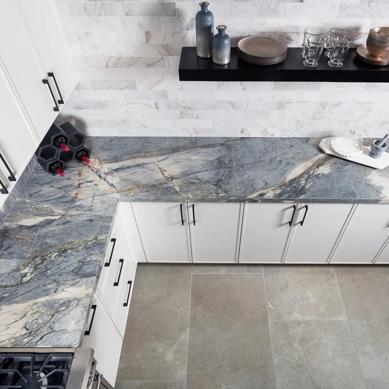 Ijen Blue Polished (counter & backsplash), Calacatta Umber Honed 3 x 12 (right wall) & Anthea Earth 24 x 48 (floor) in kitchen.