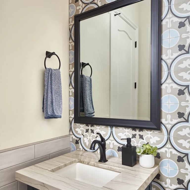 Mustang quartzite on vanity, Reverie 7 - 8 x 8 porcelain tile on right wall, Gioia Greige porcelain tile on left wall & Gioia Greige Pencil Bullnose porcelain trim in half bath.