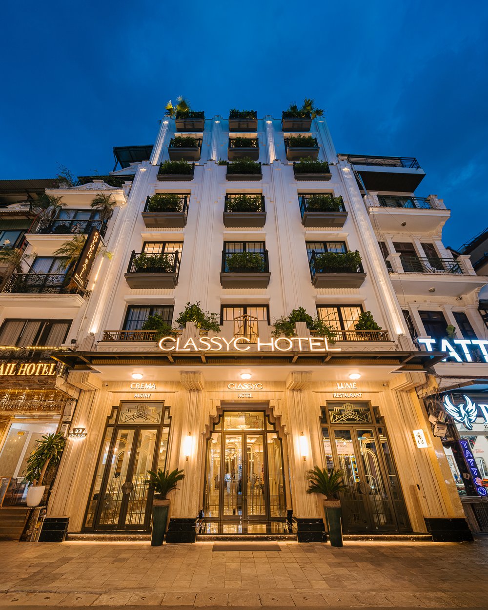 Classyc Hàng Buồm façade lit at dusk on Hàng Buồm street